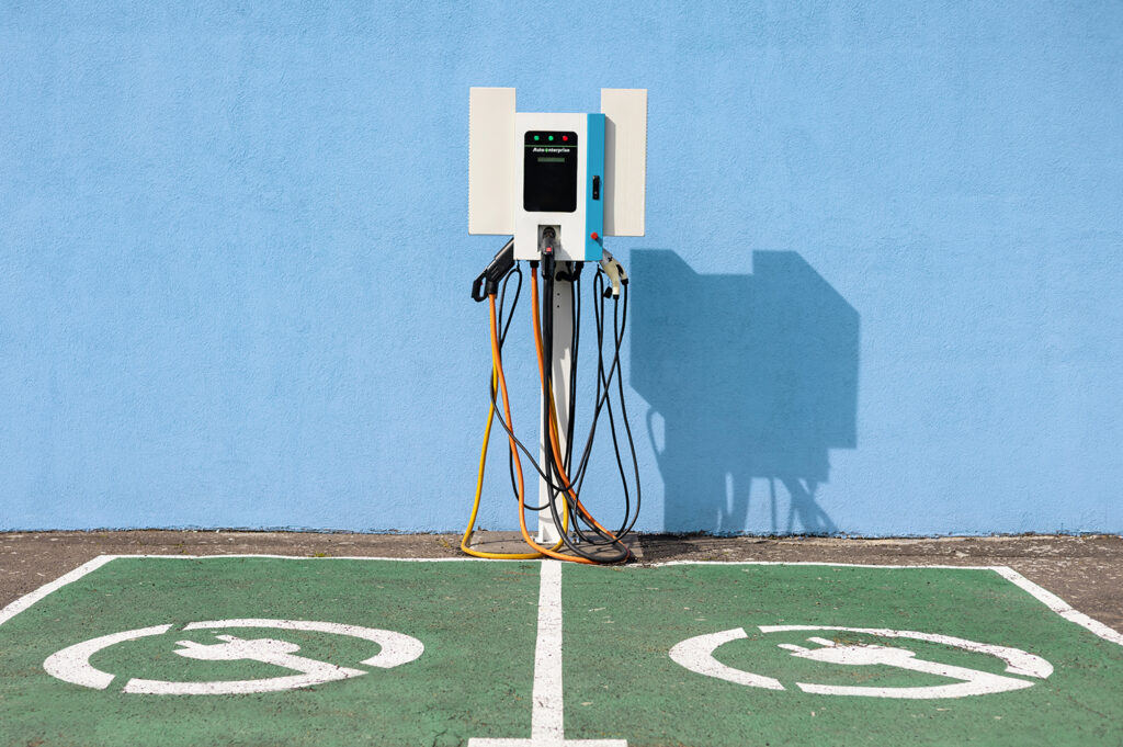 Charging point with cables in a designated charging area for electric mobility equipment.